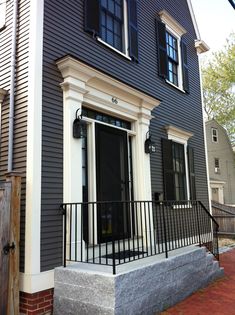 a black house with white trim and windows