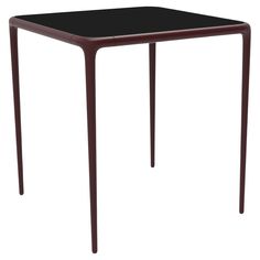 a small black table on a white background with no one around it or someone else