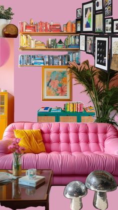 a living room with pink furniture and pictures on the wall