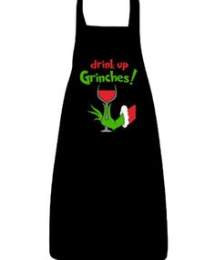 a black apron with the words drink up grinches and a glass of wine on it