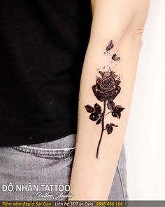 a black rose tattoo on the left arm