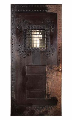 an old door with iron bars on it