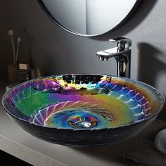 a bathroom sink with a colorful glass bowl