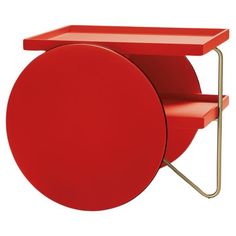 a red table with a shelf on it