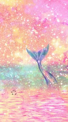 an image of a mermaid tail floating in the ocean with stars and sparkles on it