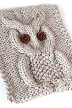 a close up of a knitted object with buttons