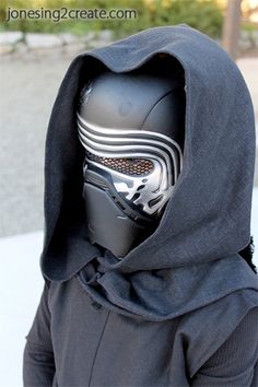 a person wearing a darth vader mask and hood