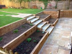 an outdoor garden with steps leading up to the grass