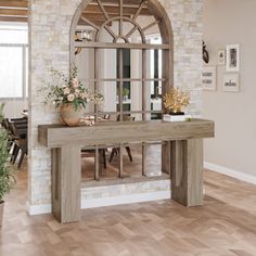 a large wooden table sitting in the middle of a living room next to a window