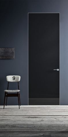 a chair sitting in front of a black door