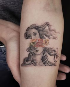 a woman's face with flowers in her hair is shown on the left arm