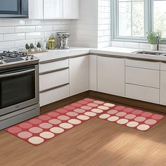 a kitchen area with a stove, sink and dishwasher on the floor in front of an oven