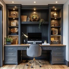 a home office with built in desk and shelves