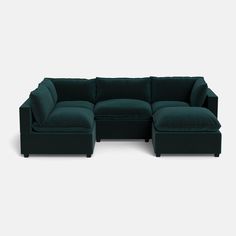 a green sectional couch sitting on top of a white floor