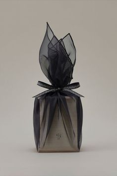 a black ribbon wrapped around a gift box