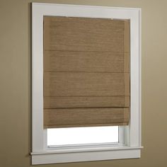 a tan roman blind in a bathroom window