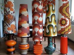 an assortment of colorful vases and lamps in a room