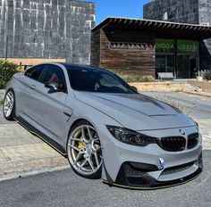 a silver car parked in front of a building