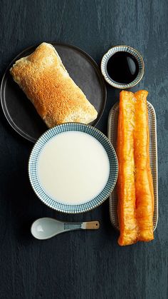 an assortment of food including bread, milk and pastry