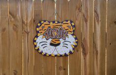 a wooden fence with a tiger face on it