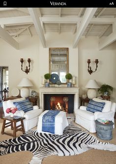 a living room filled with furniture and a fire place in the middle of a room