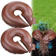 two brown inflatable numbers sitting on top of a tree stump next to a potted plant