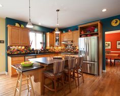 a kitchen with wooden floors and blue walls