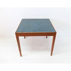 a wooden table with blue tiles on it