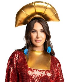 a woman in a red sequin dress and gold helmet with blue earrings