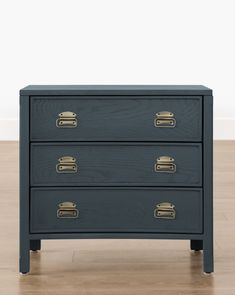 a black dresser with gold handles on it