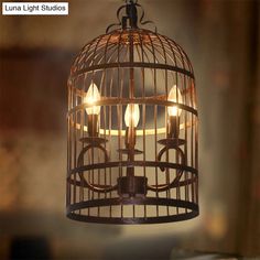 a light that is inside of a birdcage with three lights on top of it