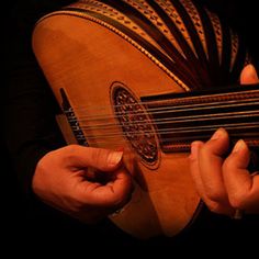 a person holding an acoustic guitar in their hands