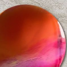 an orange and pink plate sitting on top of a table