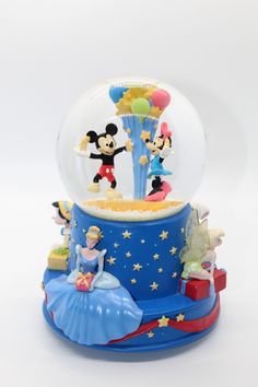 there is a snow globe with mickey and minnie on it