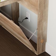 a wooden shelf with an electrical outlet in it