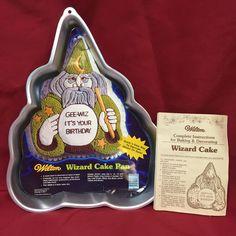 the wizard cake pan is next to it's packaging