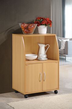 a wooden cabinet with bowls and pitchers on top of it in a living room next to a couch