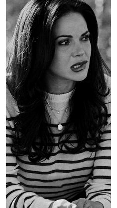 a black and white photo of a woman with long hair