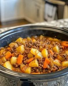 a crock pot filled with ground beef and potatoes