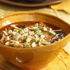 a close up of a bowl of soup on a table