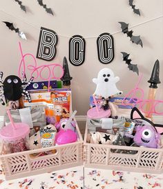 two baskets filled with halloween items on top of a table