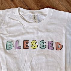 Crazy Cool Threads Watercolor Blessed Tee Shirt. Size Medium. New Without Tags Multicolor Pre-shrunk Graphic Tee, Colorful Casual T-shirt With Letter Print, Spring Graphic Tee With Rainbow Print, Trendy Rainbow T-shirt For Spring, Trendy Cotton T-shirt With Rainbow Print, Spring Multicolor T-shirt With Text Print, Multicolor Graphic Tee Shirt, Spring Multicolor Shirt With Letter Print, Colorful Cute Cotton T-shirt