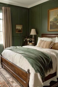 a bedroom with green walls and white bedding