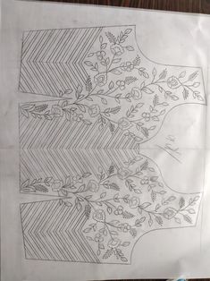 a piece of paper that has been drawn on top of it with flowers and leaves