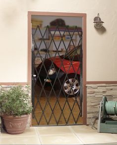 A folding steel gate is an affordable and functional way to secure various openings. The accordion gate expands up to 52-in. wide and mounts left or right within the opening or on the surface. Holes are pre-drilled for a padlock. Hinges allow the gate to swing out for full access to the opening when needed. The powder coated finish keeps the gate maintenance free. RELIABILT 48-in x 80-in Black Steel Recessed or Surface Mount Universal/Reversible Security Door | 9154805-RB Bunny Proofing, Burglar Proof, Steel Security Doors, Door Sweep, Security Doors, Modern Barn Door, West Home, Steel Gate, Door Manufacturer