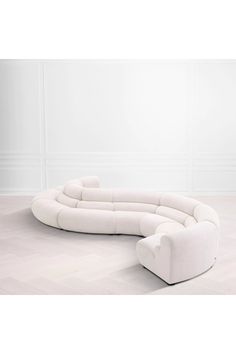 a white couch sitting on top of a hard wood floor