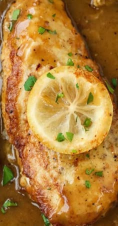 chicken with gravy and lemon served in a pan