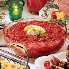 a table topped with lots of food and dishes filled with different types of meats