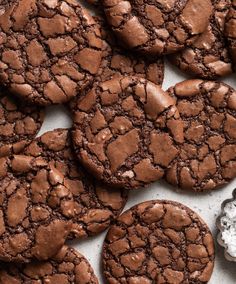 chocolate cookies with white crumbs on a table