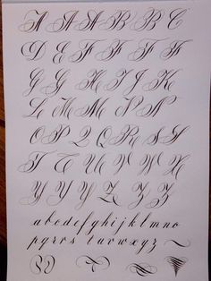 the upper and lower letters of an old fashioned calligraphy book, with black ink